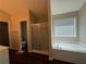 Bathroom boasts a bathtub, shower, tile, and a window, creating a bright and clean space at 124 Sparkling Spring Trl, Mcdonough, GA 30252