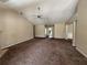 Expansive living room featuring neutral walls, vaulted ceilings with a ceiling fan, and plush carpet at 124 Sparkling Spring Trl, Mcdonough, GA 30252