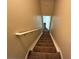 Carpeted stairway with white railing leads to the upper level of the home at 124 Sparkling Spring Trl, Mcdonough, GA 30252