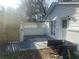 Backyard patio with newly painted white brick, partial fence, and convenient access from the house via french doors at 1905 Robinhill Ct, Tucker, GA 30084