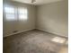 Cozy bedroom with neutral walls, carpet, and natural light from the window at 1905 Robinhill Ct, Tucker, GA 30084