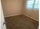 Cozy bedroom with neutral walls, carpet, and natural light from the window at 1905 Robinhill Ct, Tucker, GA 30084