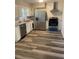 Modern kitchen with stainless steel appliances, white cabinets, and modern hardwood floors at 1905 Robinhill Ct, Tucker, GA 30084