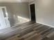The Living Room has wood-look flooring with a white door and a large window at 1905 Robinhill Ct, Tucker, GA 30084