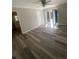 Bright living room features ceiling fan, door to outside, and modern hardwood floors at 1905 Robinhill Ct, Tucker, GA 30084