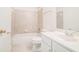 Bathroom featuring a shower over tub, a single sink vanity, and tile flooring at 2717 High Creek Run, Dacula, GA 30019