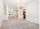 Open-concept dining room features a chandelier and wainscoting at 2717 High Creek Run, Dacula, GA 30019