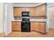 Kitchen area features wooden cabinets, black appliances, and sleek countertops at 2717 High Creek Run, Dacula, GA 30019