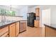 Bright kitchen with stainless steel appliances, wood floors, and ample cabinet space at 2717 High Creek Run, Dacula, GA 30019