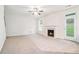 Bright living room features a fireplace, a ceiling fan and a door to the outside at 2717 High Creek Run, Dacula, GA 30019