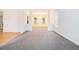 Spacious living room with neutral carpet, columns, and bright lighting at 2717 High Creek Run, Dacula, GA 30019