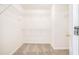 A bright walk-in closet with shelves and carpeted floor at 2717 High Creek Run, Dacula, GA 30019