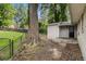 A spacious backyard that includes a fenced in area, mature trees, and the back side of the house at 3294 Renault Se Rd, Atlanta, GA 30354
