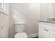Powder room featuring a granite countertop, white cabinets, and modern fixtures, offering a clean and functional space at 3294 Renault Se Rd, Atlanta, GA 30354