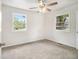 Bright bedroom featuring neutral walls, carpet floors, and two windows with views of the outdoors at 3294 Renault Se Rd, Atlanta, GA 30354