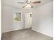 Bright bedroom featuring neutral walls, carpet floors, a ceiling fan with light, and a window with view of the outdoors at 3294 Renault Se Rd, Atlanta, GA 30354