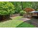 Backyard view with a large tree and covered patio at 3665 Pine St, Atlanta, GA 30340