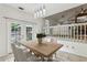 Dining area with a wooden table set for four, with French doors leading to an outdoor view at 3665 Pine St, Atlanta, GA 30340