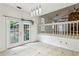Bright dining room features French doors, tile floor, and modern lighting at 3665 Pine St, Atlanta, GA 30340