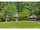 Charming two-story home with a well-manicured front lawn and mature trees offering shade and privacy at 3665 Pine St, Atlanta, GA 30340