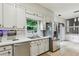 Well-lit kitchen with stainless steel appliances, white cabinets, and a view to an adjacent area through the window at 3665 Pine St, Atlanta, GA 30340