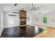 Spacious living room with a unique stone fireplace, hardwood floors, and large windows showcasing the outdoor view at 3665 Pine St, Atlanta, GA 30340