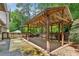 This backyard patio features a covered pergola with wooden deck and concrete extension at 3665 Pine St, Atlanta, GA 30340