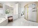 Bright primary bathroom with double vanity, white tile floors, shower, and tub at 3944 Blustery Ne Way, Marietta, GA 30066