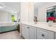 Bright bathroom with a large vanity, white cabinets, and a view into the bedroom area at 3944 Blustery Ne Way, Marietta, GA 30066