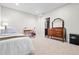 Bedroom with light walls, desk, dresser with mirror, and adjacent doorway with patterned floor visible at 3944 Blustery Ne Way, Marietta, GA 30066