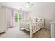 Charming bedroom featuring soft carpet, a cozy bed, and a window with views of lush greenery at 3944 Blustery Ne Way, Marietta, GA 30066