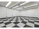 Spacious, well-lit garage with black and white checkered flooring and electrical outlets at 3944 Blustery Ne Way, Marietta, GA 30066