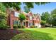 Beautiful two-story brick home with manicured front yard, black shutters, and a two-car garage at 3944 Blustery Ne Way, Marietta, GA 30066