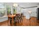 Bright eat-in kitchen featuring white cabinets, stainless appliances, island and breakfast table with backyard access at 3944 Blustery Ne Way, Marietta, GA 30066