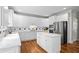 Gourmet kitchen with white cabinets, island, stainless steel appliances, and breakfast area at 3944 Blustery Ne Way, Marietta, GA 30066