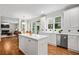 Open kitchen showcasing an island, stainless steel appliances, and seamless flow into the breakfast and living areas at 3944 Blustery Ne Way, Marietta, GA 30066