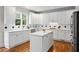 Well-appointed kitchen with white cabinets, island, stainless steel appliances, and black and white backsplash at 3944 Blustery Ne Way, Marietta, GA 30066