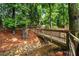 Wooden bridge over creek with stone embankment, enhancing the natural beauty of the surroundings at 3944 Blustery Ne Way, Marietta, GA 30066