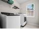 Laundry room with washer, dryer, storage shelf, and window for natural light at 3944 Blustery Ne Way, Marietta, GA 30066