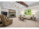 Cozy living room with stone fireplace, wooden ceiling beam, recessed lighting, and natural light from outdoor views at 3944 Blustery Ne Way, Marietta, GA 30066