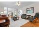 Bright living room features hardwood floors, a ceiling fan, and an open layout with access to other areas at 3944 Blustery Ne Way, Marietta, GA 30066