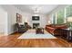 Cozy living room boasts hardwood floors, fireplace, and abundant natural light from large windows at 3944 Blustery Ne Way, Marietta, GA 30066