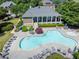 Community pool with sun loungers, tables, and a covered pavilion, surrounded by trees and landscaped gardens at 3944 Blustery Ne Way, Marietta, GA 30066