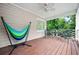 Relaxing covered porch featuring a colorful hammock and seating area for outdoor enjoyment at 3944 Blustery Ne Way, Marietta, GA 30066