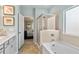Modern bathroom featuring a tub, walk in shower, and gray cabinets at 379 Morgan Rd, Carrollton, GA 30116