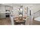 Open-concept dining area with modern pendant lighting, stainless steel appliances and an adjacent kitchen island at 379 Morgan Rd, Carrollton, GA 30116