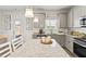 Bright kitchen with granite countertops, an island with seating, and modern fixtures at 379 Morgan Rd, Carrollton, GA 30116