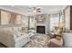 Bright living room featuring a cozy fireplace, neutral-toned furniture, and large windows for natural light at 379 Morgan Rd, Carrollton, GA 30116