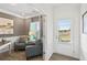 Well-lit office with comfortable seating and a view to the exterior of the home at 379 Morgan Rd, Carrollton, GA 30116
