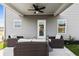 Cozy covered patio with comfortable seating, ceiling fan, and outdoor living space at 379 Morgan Rd, Carrollton, GA 30116